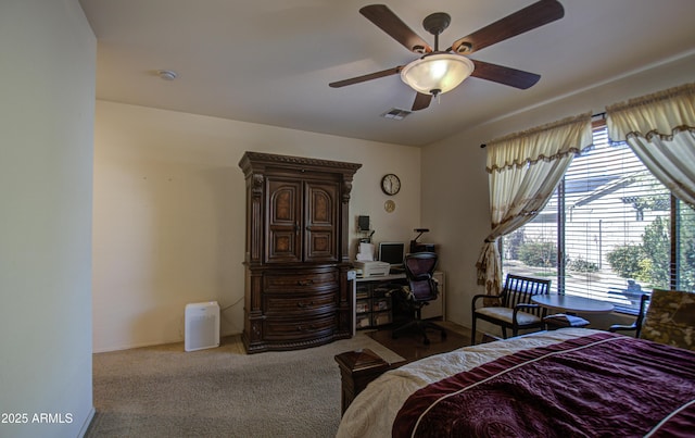 bedroom featuring multiple windows, ceiling fan, visible vents, and carpet flooring