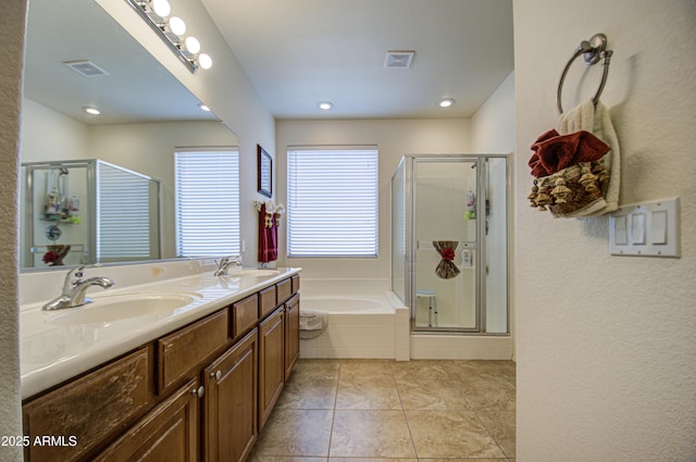 full bath featuring a stall shower, visible vents, and a sink