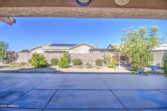 view of front facade featuring a patio area and a fenced backyard