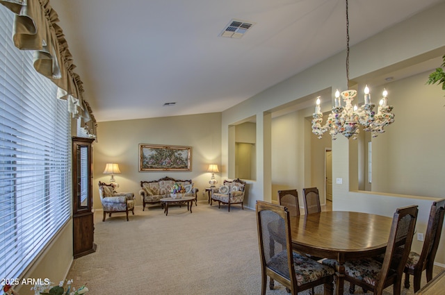 dining room featuring light colored carpet, visible vents, vaulted ceiling, and an inviting chandelier