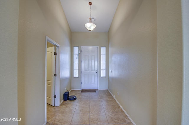 foyer with light tile patterned flooring, visible vents, and baseboards