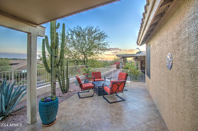 view of patio terrace at dusk