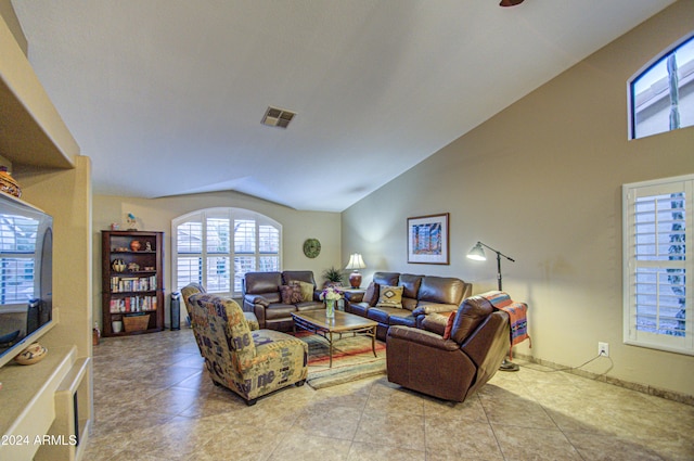 living room featuring light tile patterned flooring and vaulted ceiling