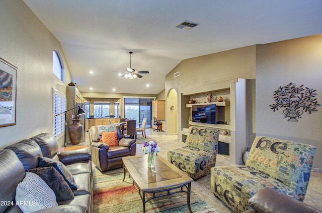 living room with ceiling fan, built in features, and vaulted ceiling