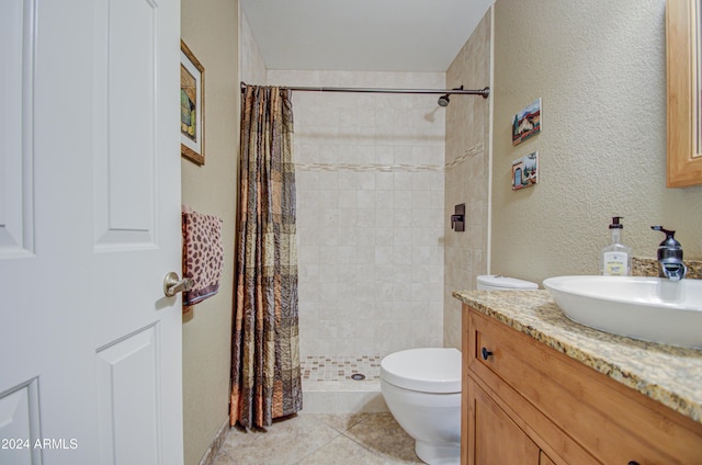 bathroom with walk in shower, tile patterned floors, vanity, and toilet