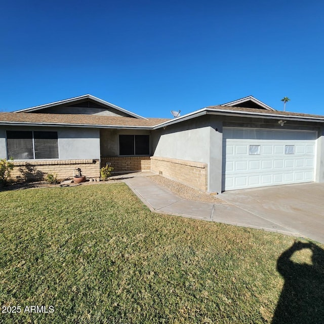 ranch-style home featuring brick siding, a front lawn, an attached garage, and stucco siding