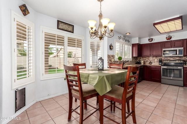 tiled dining space with a notable chandelier