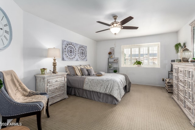 bedroom featuring light colored carpet and ceiling fan