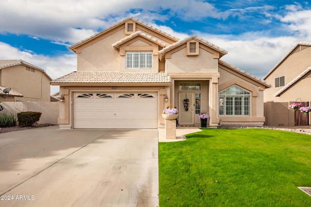 mediterranean / spanish house with a front yard and a garage