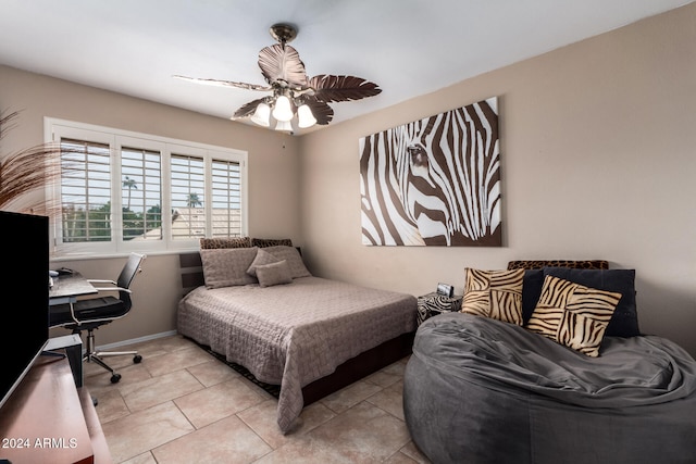 tiled bedroom featuring ceiling fan