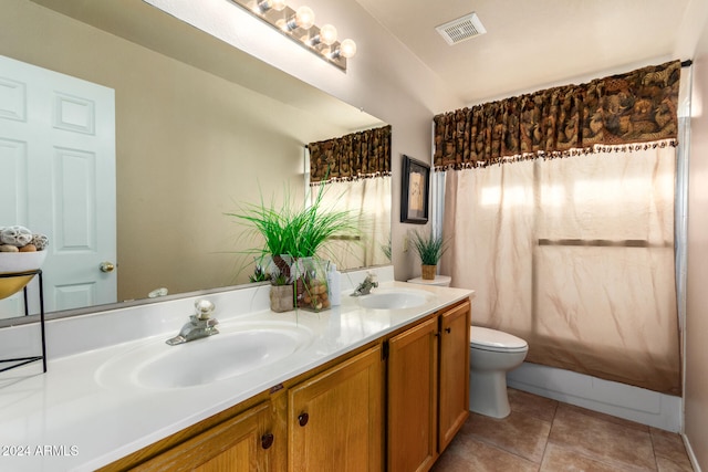 full bathroom with tile patterned floors, vanity, shower / bath combo, and toilet