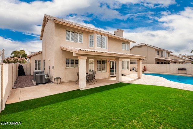 back of property with a fenced in pool, central AC, a yard, and a patio