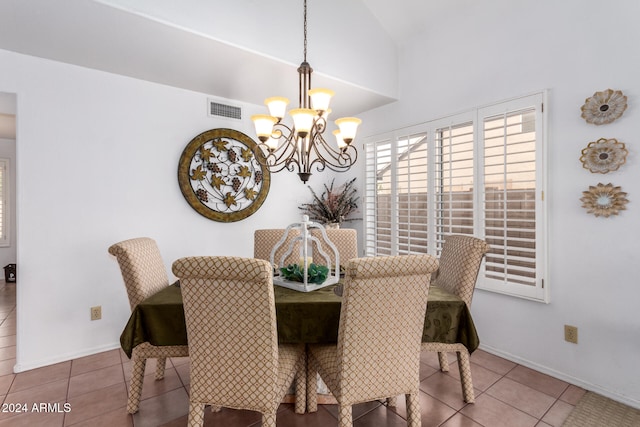 tiled dining area featuring lofted ceiling and a chandelier