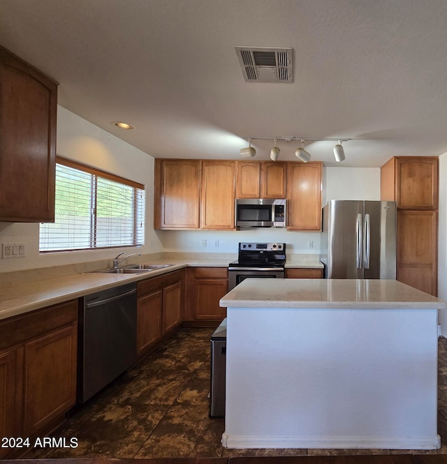 kitchen featuring a center island, sink, and stainless steel appliances