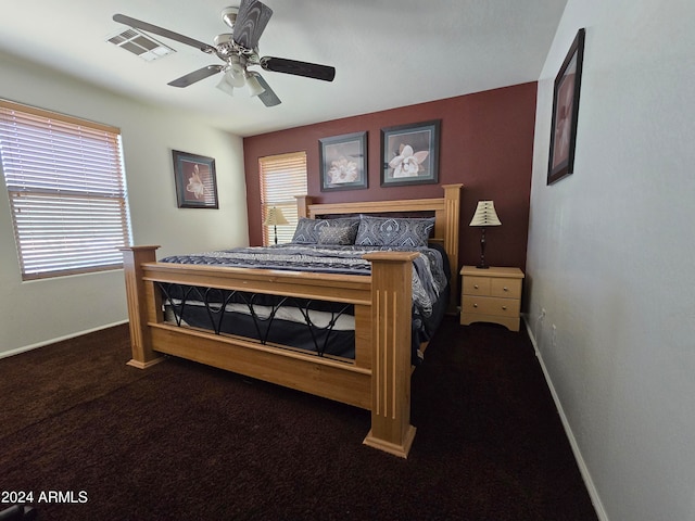 bedroom featuring dark colored carpet and ceiling fan