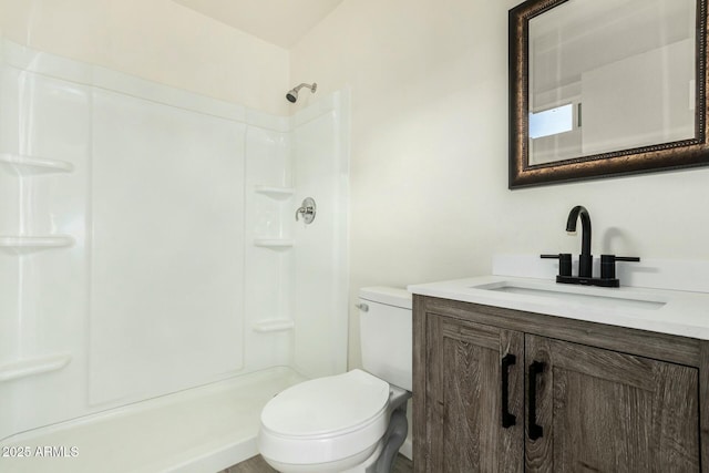 bathroom with vanity, toilet, and walk in shower