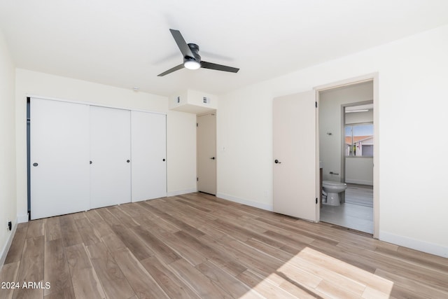 unfurnished bedroom with ensuite bathroom, light hardwood / wood-style floors, ceiling fan, and a closet