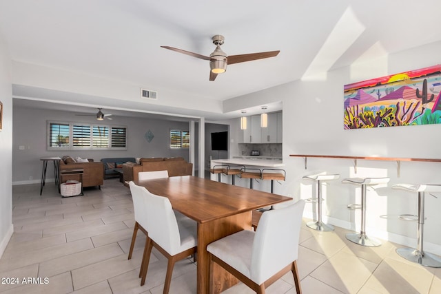 8301 E Crestwood Way, Scottsdale, AZ 85250 - dining space with a ceiling fan, light tile patterned floors, and baseboards
