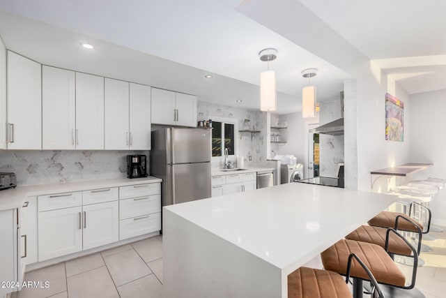 8301 E Crestwood Way, Scottsdale, AZ 85250 - kitchen with appliances with stainless steel finishes, washer and clothes dryer, a sink, tasteful backsplash, and recessed lighting