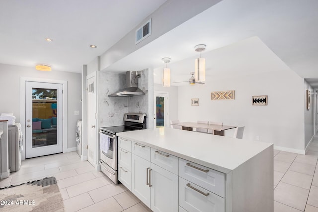 8301 E Crestwood Way, Scottsdale, AZ 85250 - kitchen featuring wall chimney range hood, electric stove, washer / clothes dryer, light tile patterned floors, and white cabinetry