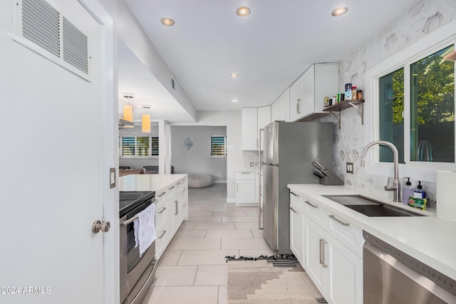 8301 E Crestwood Way, Scottsdale, AZ 85250 - kitchen featuring stainless steel appliances, a sink, recessed lighting, decorative backsplash, and light countertops