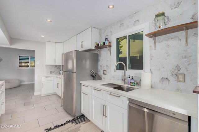 8301 E Crestwood Way, Scottsdale, AZ 85250 - kitchen featuring appliances with stainless steel finishes, open shelves, a sink, decorative backsplash, and white cabinets