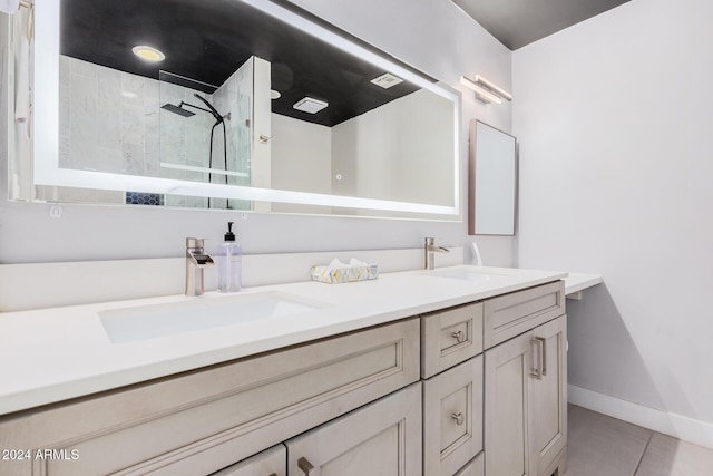 8301 E Crestwood Way, Scottsdale, AZ 85250 - bathroom featuring double vanity, tile patterned floors, a walk in shower, and baseboards