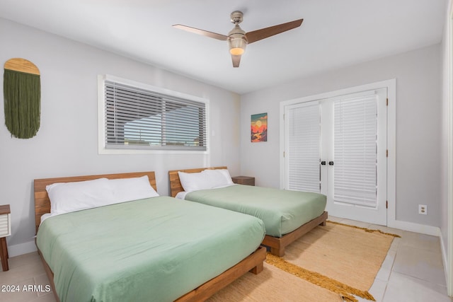 8301 E Crestwood Way, Scottsdale, AZ 85250 - tiled bedroom with baseboards and ceiling fan