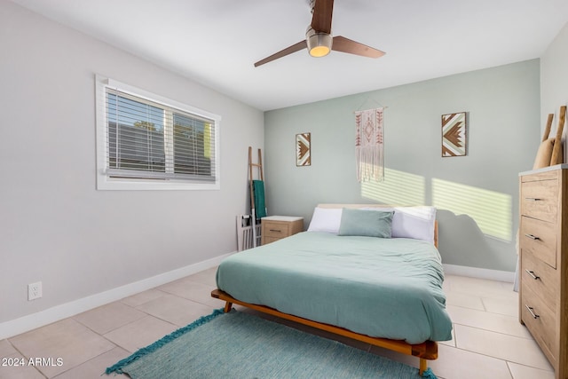 8301 E Crestwood Way, Scottsdale, AZ 85250 - bedroom with baseboards, light tile patterned floors, and a ceiling fan