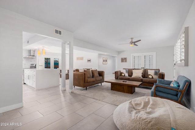 living room featuring light tile patterned floors and ceiling fan