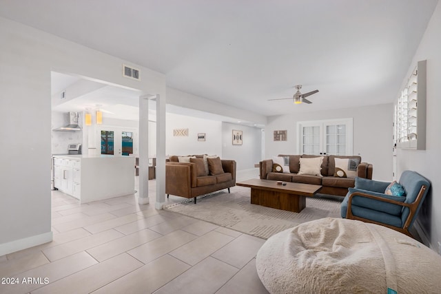 8301 E Crestwood Way, Scottsdale, AZ 85250 - tiled living room featuring ceiling fan and baseboards