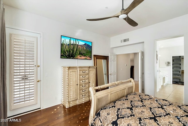 bedroom with ceiling fan, ensuite bathroom, and wood-type flooring