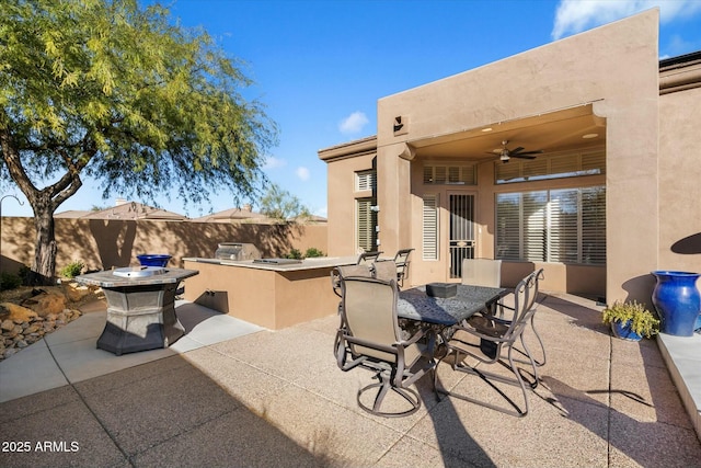 view of patio / terrace with ceiling fan, exterior kitchen, and exterior bar