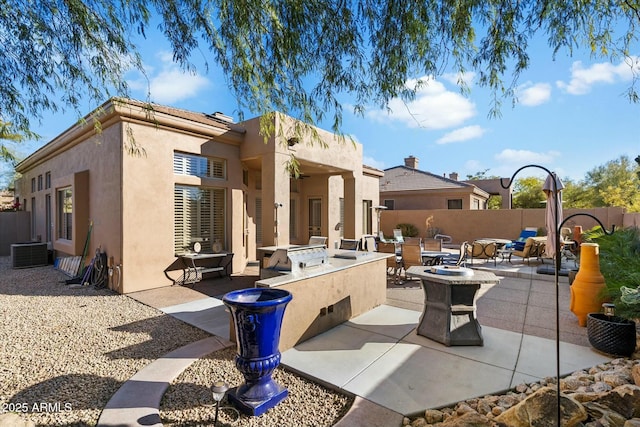 rear view of house featuring area for grilling, cooling unit, an outdoor fire pit, and a patio