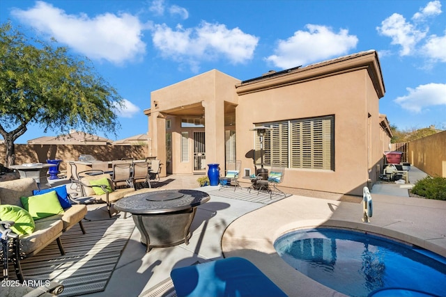 rear view of property featuring a patio area and solar panels