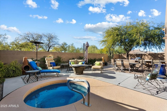 view of swimming pool featuring an in ground hot tub and a patio