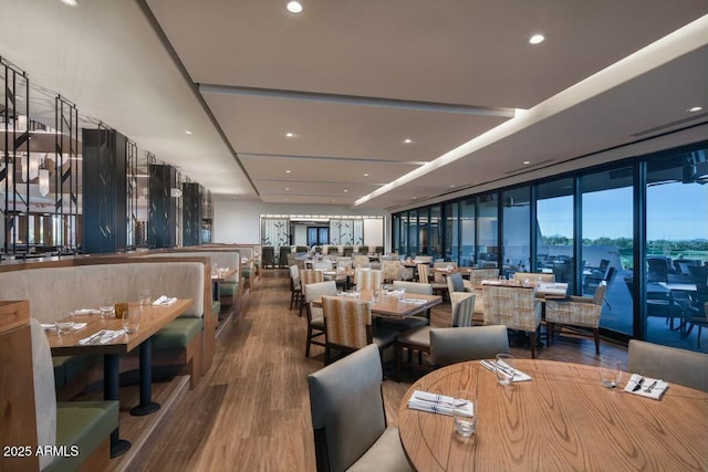 dining room with hardwood / wood-style flooring and expansive windows