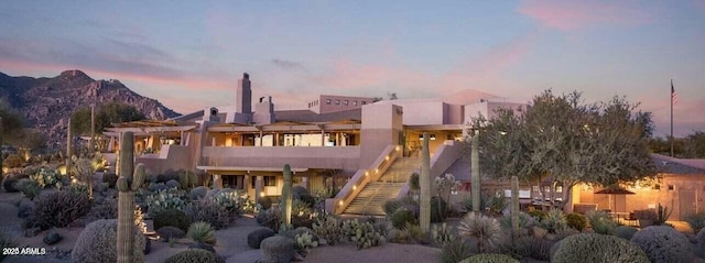 back house at dusk with a mountain view