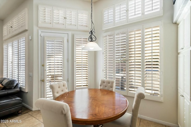 tiled dining space with a high ceiling