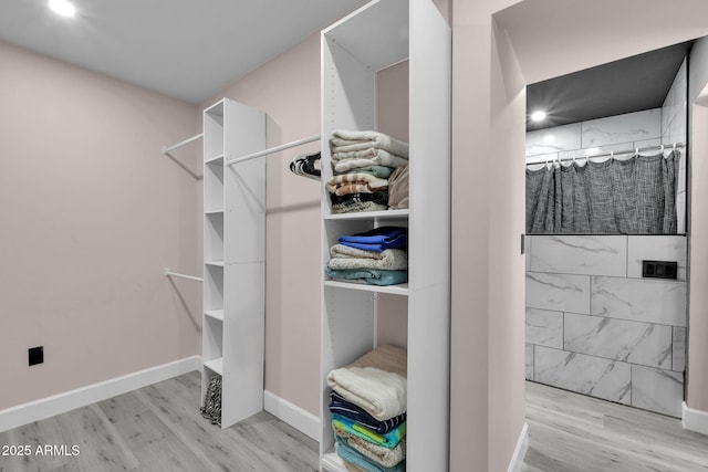 walk in closet featuring light hardwood / wood-style flooring