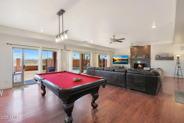 game room with a large fireplace, pool table, dark hardwood / wood-style floors, and ceiling fan