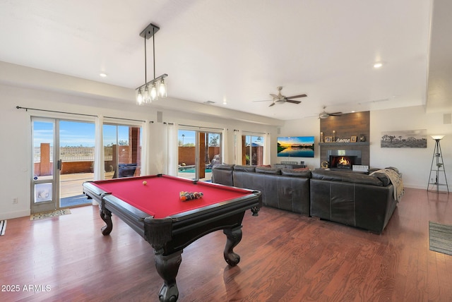 game room with a large fireplace, billiards, dark hardwood / wood-style floors, and ceiling fan