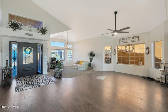 entryway featuring ceiling fan with notable chandelier, dark wood-type flooring, and high vaulted ceiling