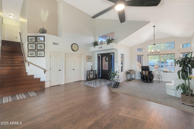 entrance foyer with hardwood / wood-style flooring, lofted ceiling, and a chandelier