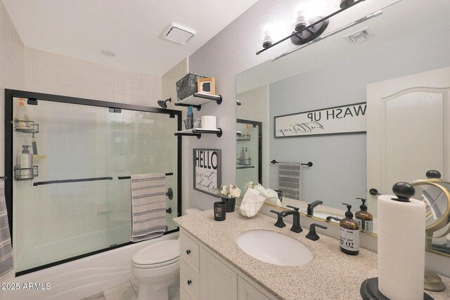 full bathroom with vanity, toilet, and combined bath / shower with glass door