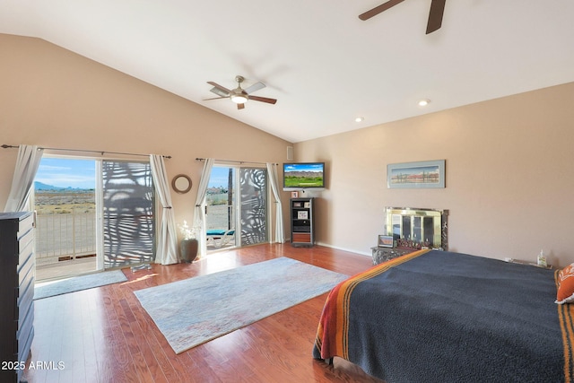 bedroom featuring multiple windows, hardwood / wood-style flooring, access to outside, and lofted ceiling