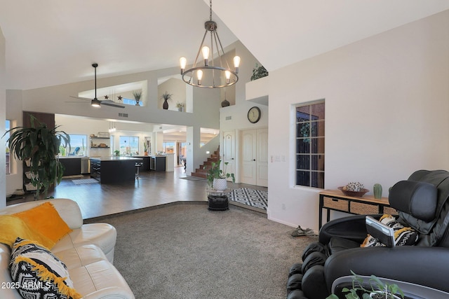 living room featuring high vaulted ceiling, carpet floors, and an inviting chandelier