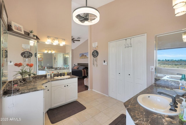 bathroom with vanity, high vaulted ceiling, and tile patterned floors