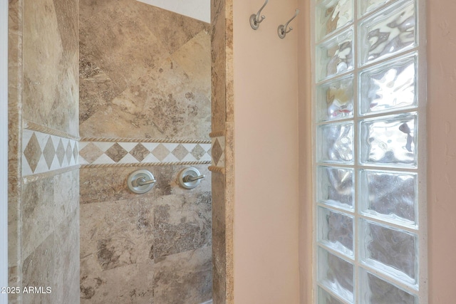 bathroom with tiled shower