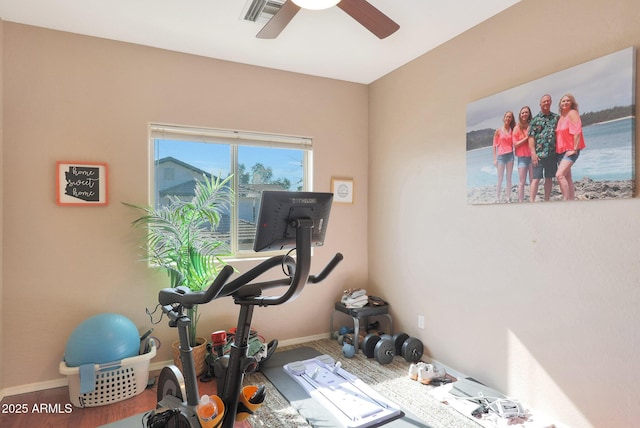 workout room with hardwood / wood-style flooring and ceiling fan